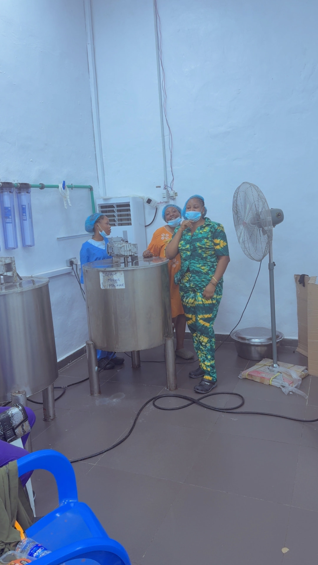 Amlat Beauty production team at the cream mixing machine
